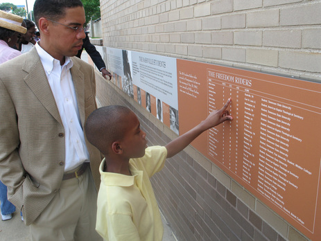 Father and son explore the Freedom Rides Museum's outdoor exhibit